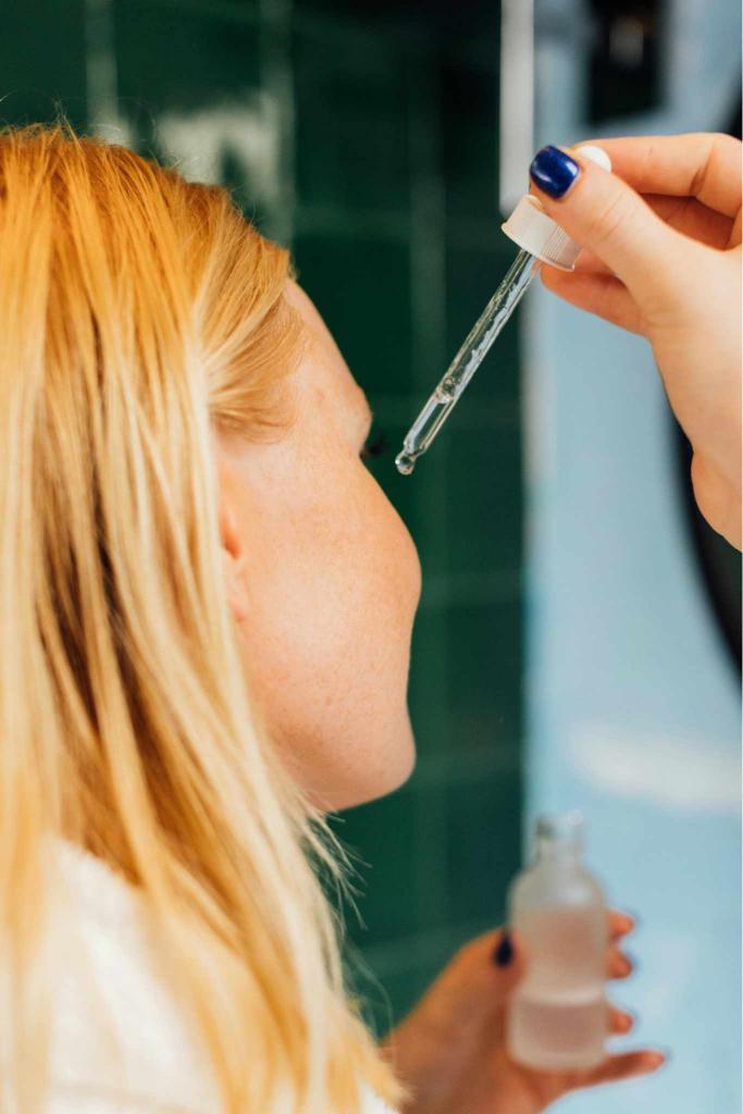 woman applying serum to face