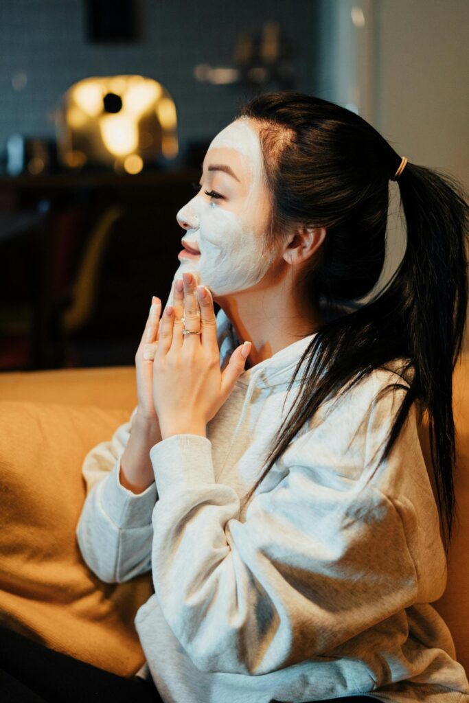 woman moisturizing her face