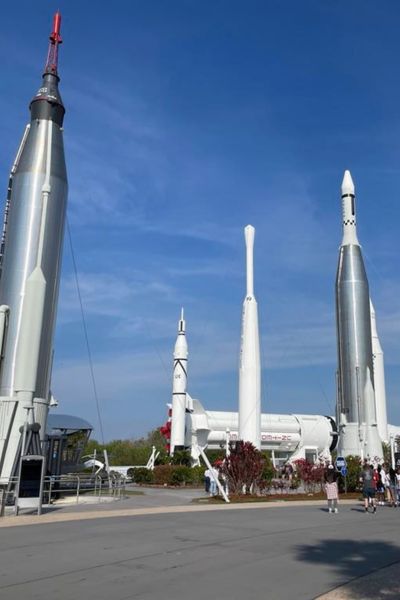 Visitors explore impressive rocket exhibits at a space museum.