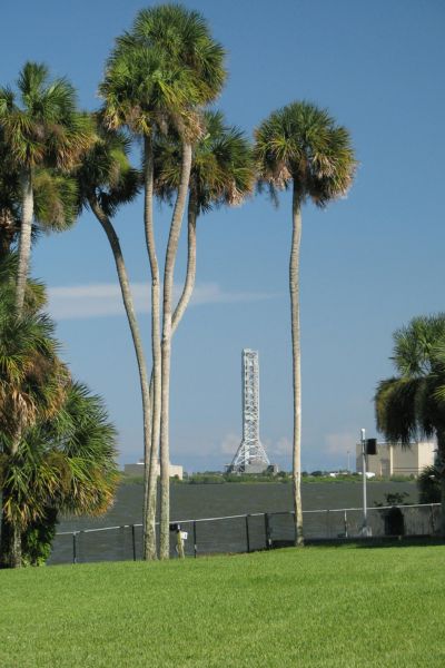 The tall launch pad stands against a clear blue sky.