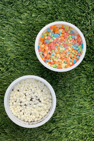 A mix of white and colorful space ice cream on green grass.