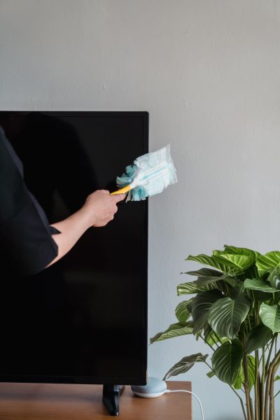 Brightening up the living room by removing dust from the TV.