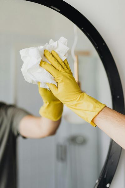 cleaning a bathroom mirror