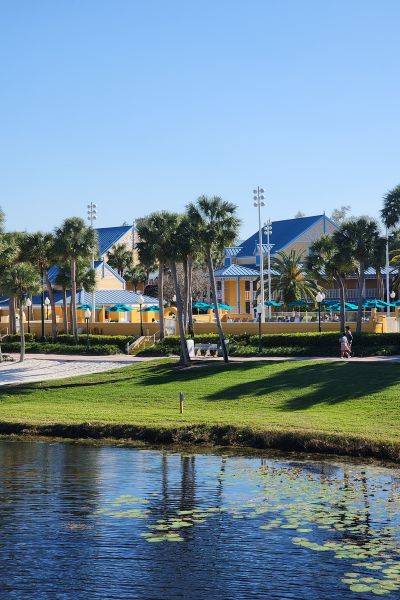 Bright yellow buildings contrast beautifully with palm trees and a clear blue sky.