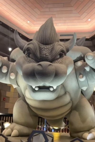 A large stone statue of a fierce creature standing in a well-lit room.