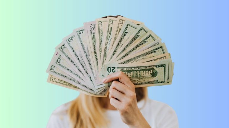 Woman holding fanned money from side hustle earnings