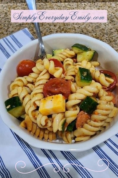 Serving of pasta salad for a crowd in a single serving size bowl with a fork