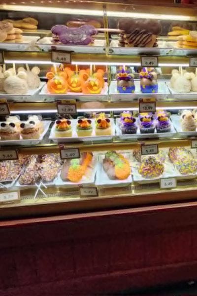 Halloween-themed treats and decorated desserts displayed in a bakery case at Walt Disney World during Mickey’s Not-So-Scary Halloween Party.