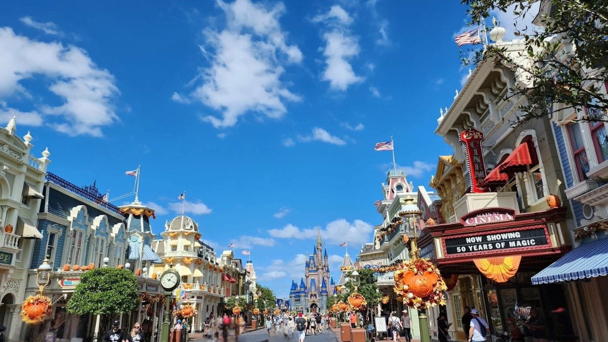 Fall decorations line Main Street, U.S.A. at Magic Kingdom during Mickey’s Not-So-Scary Halloween Party at Walt Disney World, with Cinderella Castle in the distance.